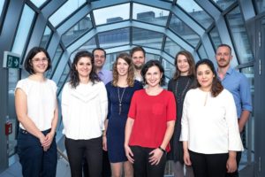 The Cahová group standing in the glass atrium walkway of the institute