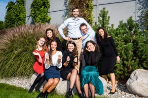 The Cahová group in 2021, posing outdoors among ornamental grasses and pines