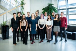 The Cahová group in 2023, standing in a row indoors in front of tall windows
