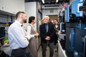President Petr Pavel in conversation with group members beside the mass spectrometry instruments